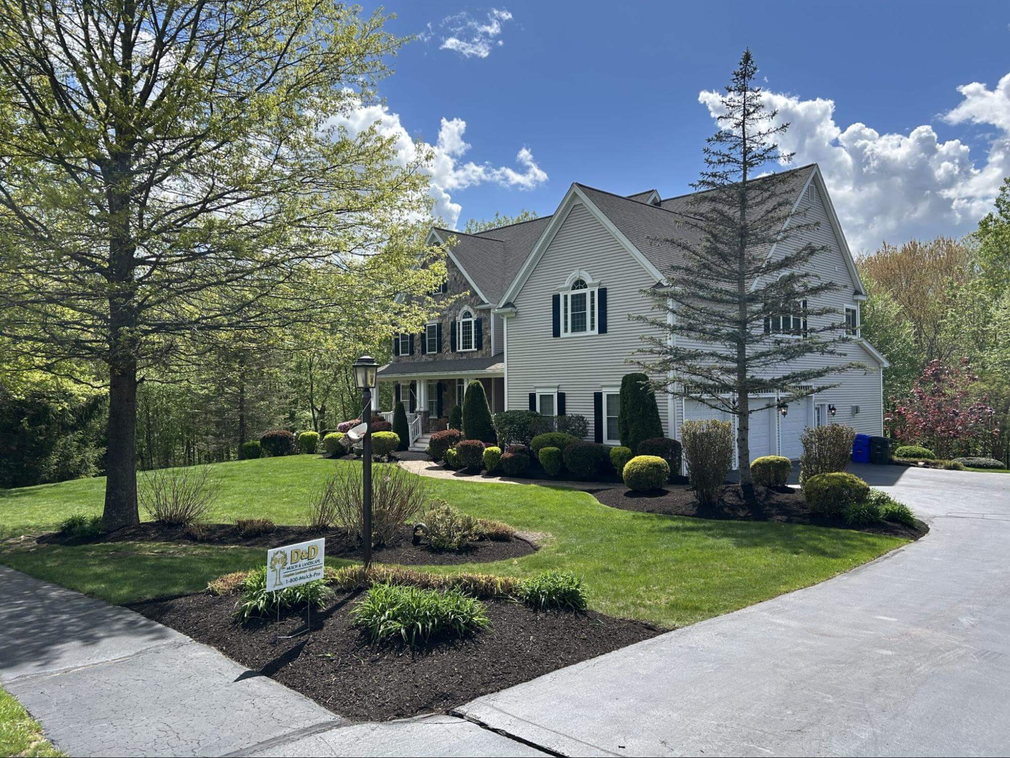 Fresh mulch installed around residential home landscape beds and shrubs
